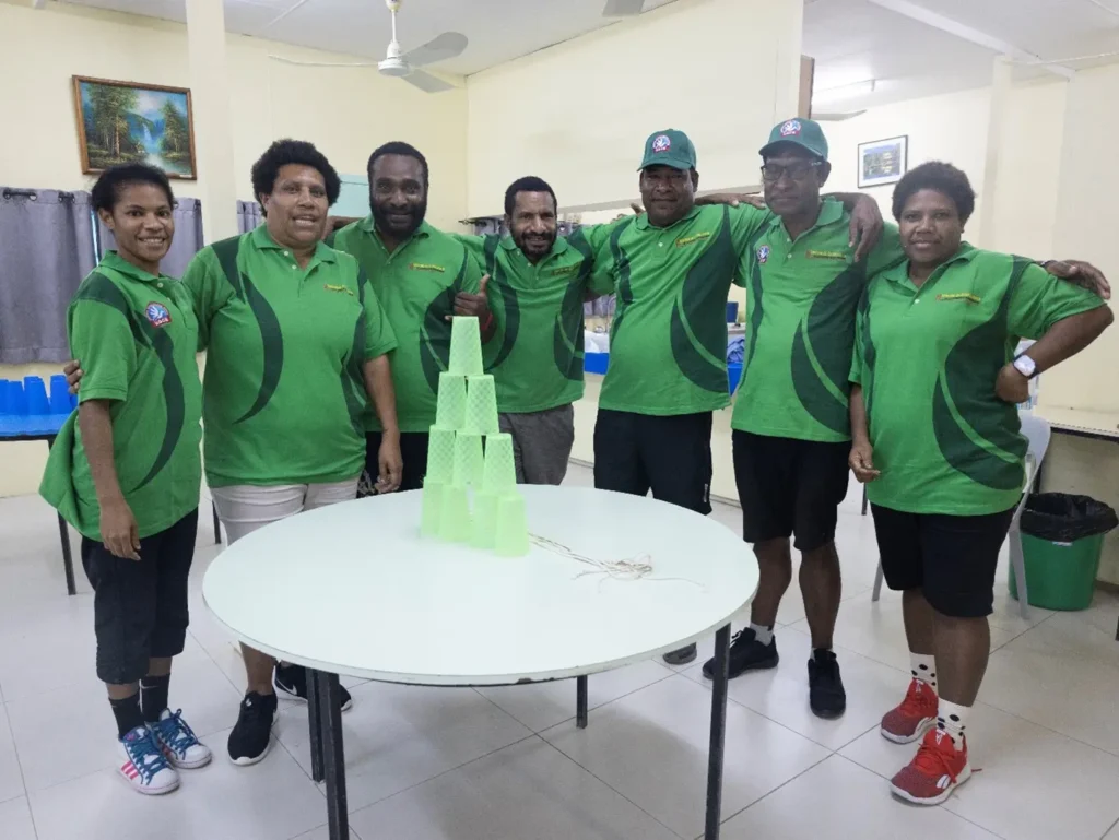 Team Green celebrating after a successful cup stacking