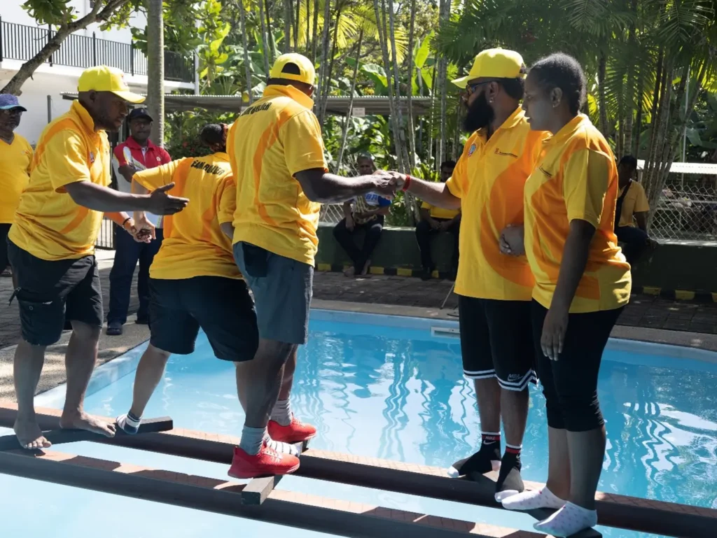 Team Gold supporting each other in pool crossing